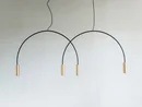 Moderne minimalistische Pendelleuchte mit goldenen Zylindern und schwarzen Bögen